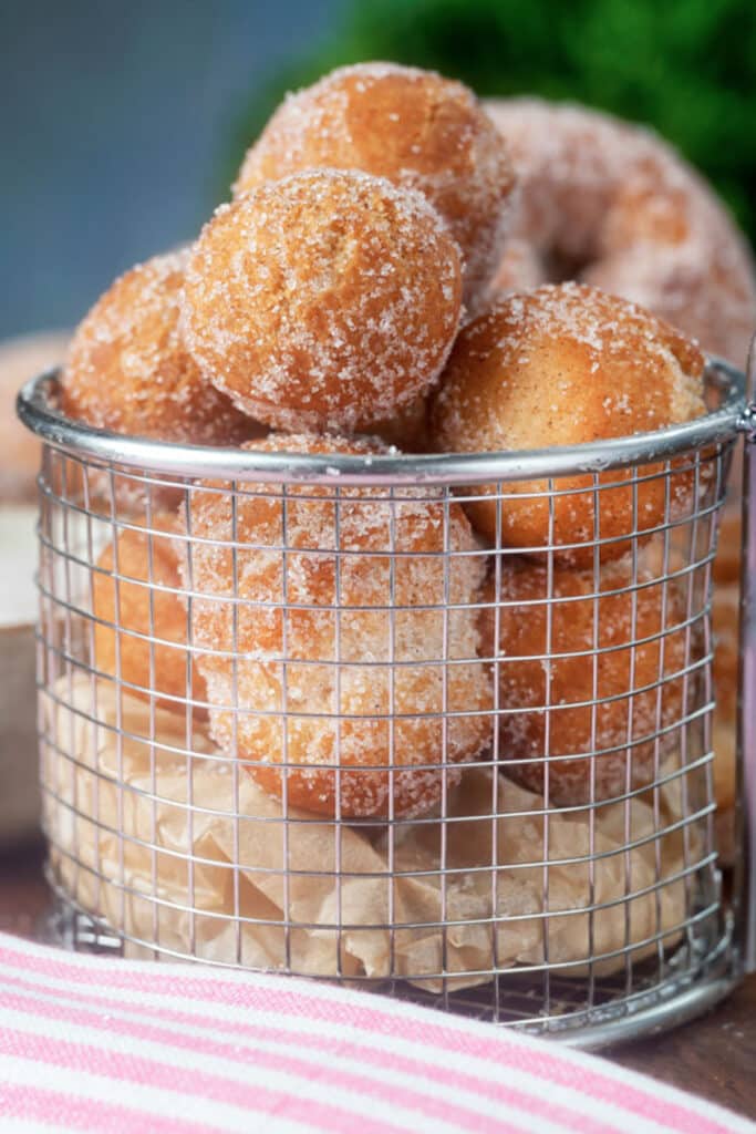Donut holes in a wire basket.