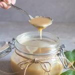 caramel sauce pouring from a spoon