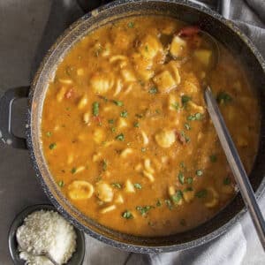 Chickpea soup in a black pot.