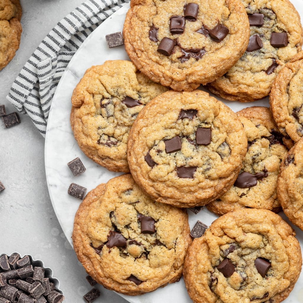 Chocolate chunk cookies on a white plate.