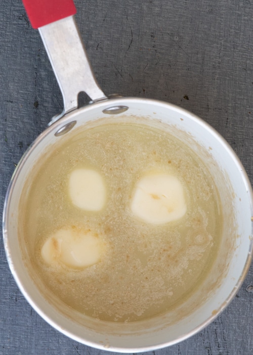 Adding the butter to the pot.