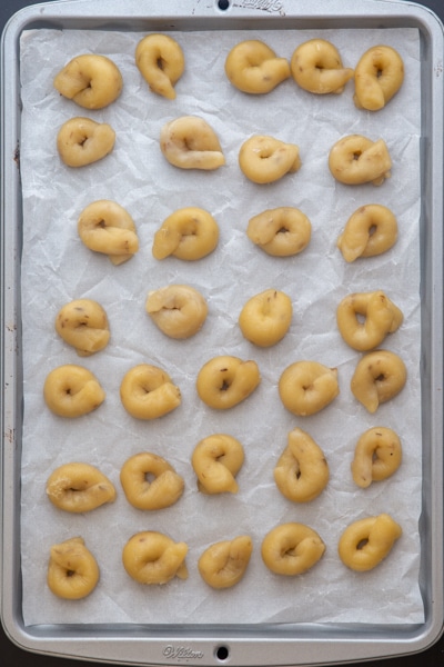 taralli ready for baking on a parchment paper cookie sheet.