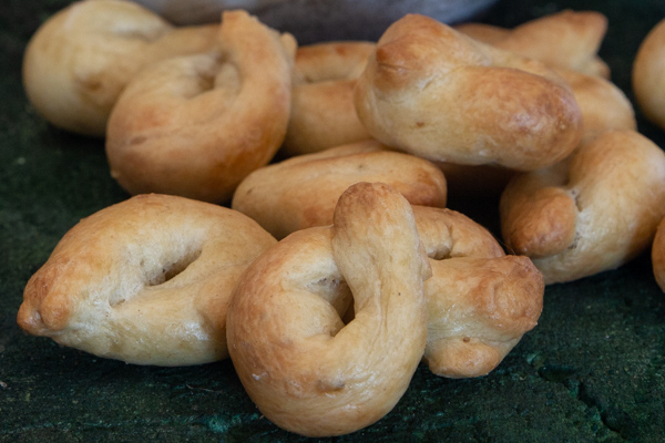 up close taralli on a black board.