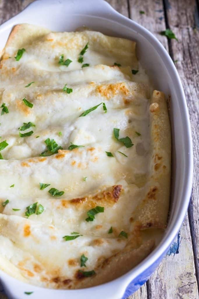 Cannelloni in a white baking dish.