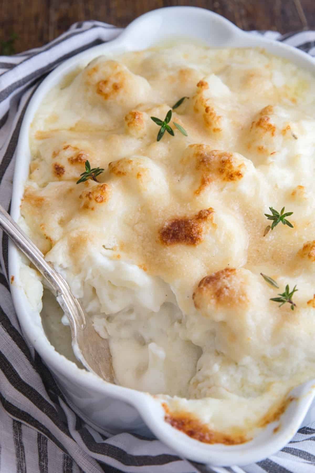 Cauliflower casserole in a white baking dish.