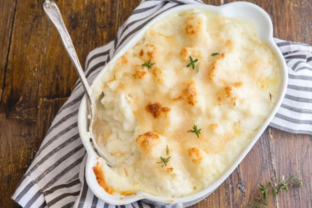 Cauliflower casserole in a white baking dish.