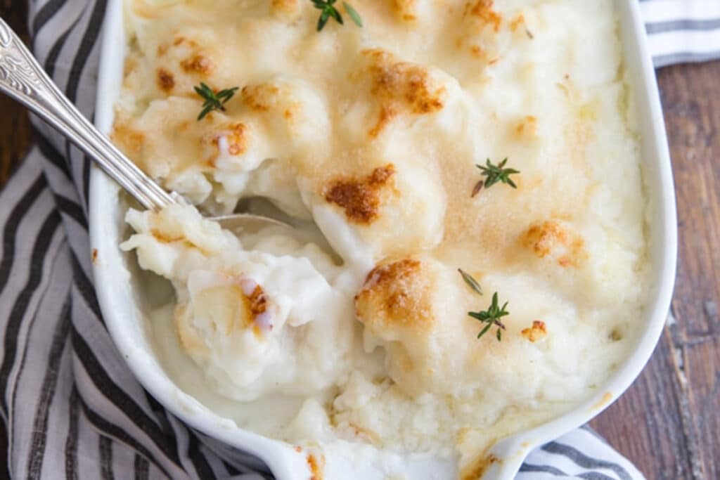 Casserole in a white pan with a silver spoon.