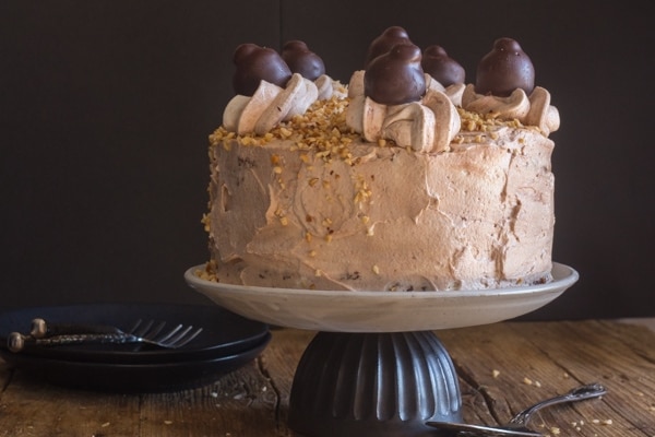chocolate birthday cake on a white cake stand