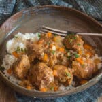 Garlic meatballs and rice in a brown bowl.