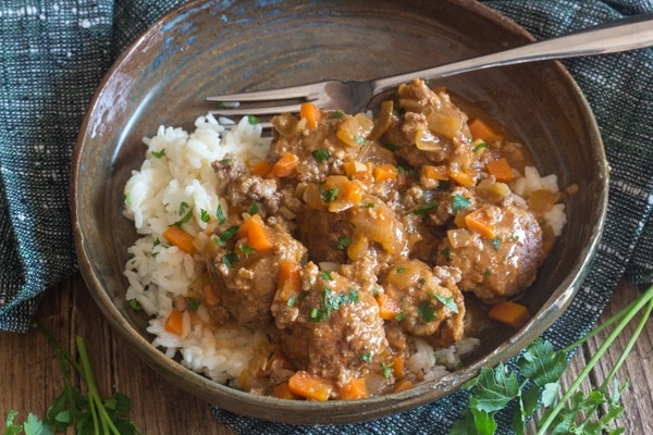 little meatballs in a brown plate with rice
