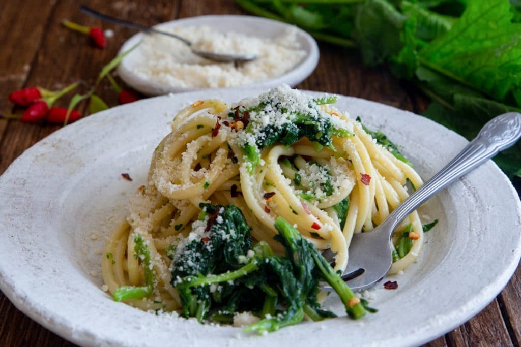Pasta with broccoli rabe on a white plate.