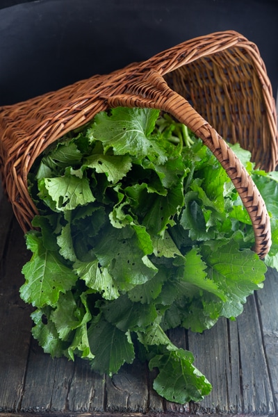Broccoli rabe in a basket.