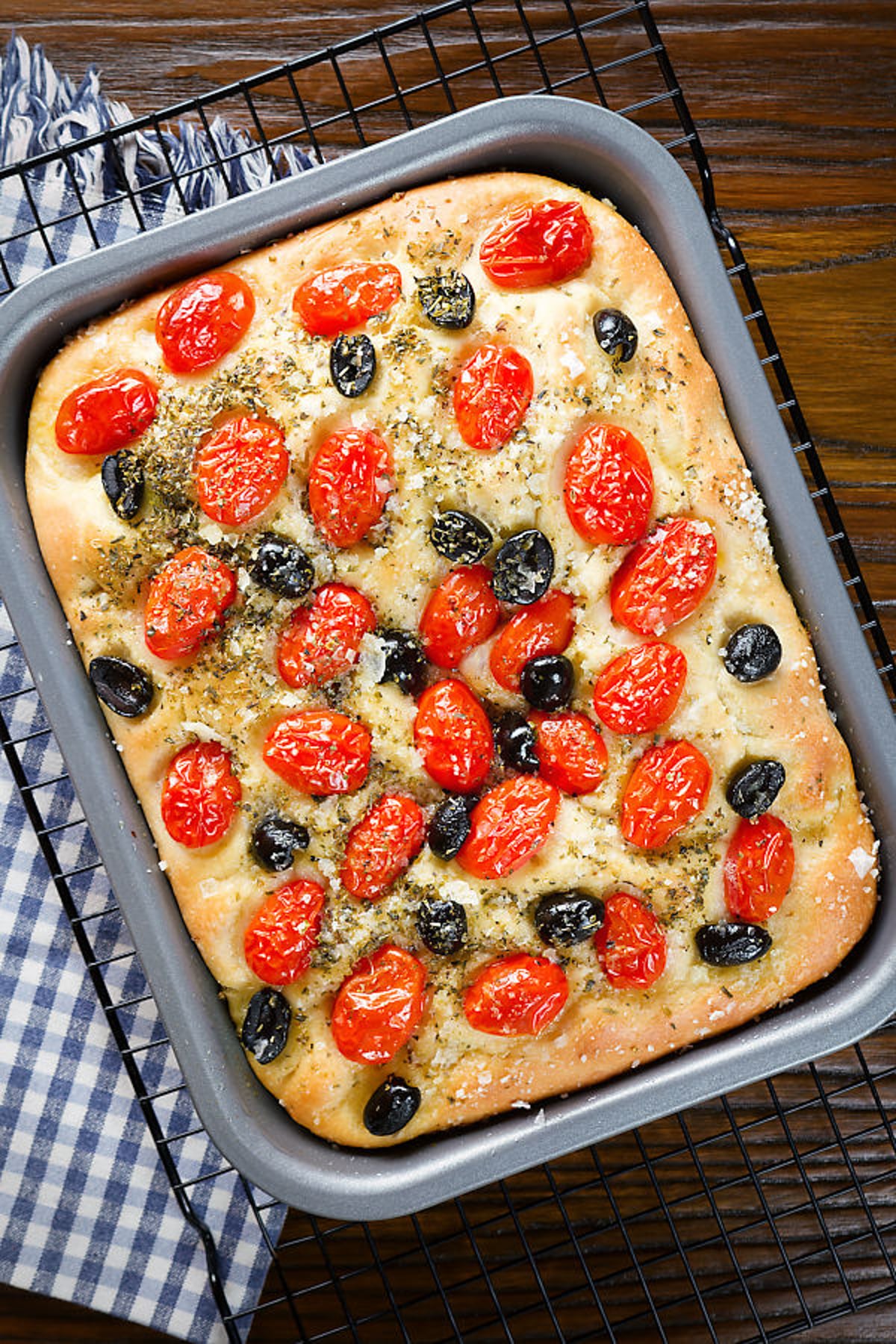 Pugliese focaccia in a baking pan.