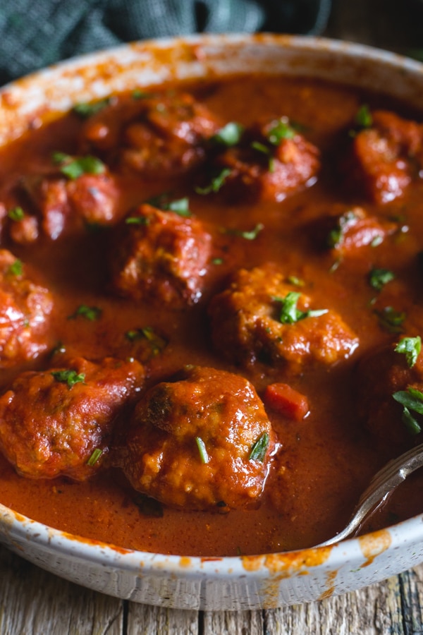 Italian meatballs in a red sauce in a white pan