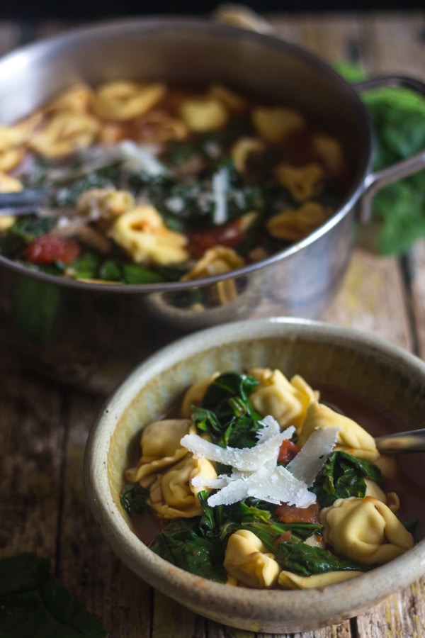 tortellini soup in a pot and in a bowl