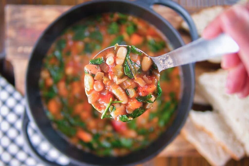 Two bean soup in a pot and on a ladle.