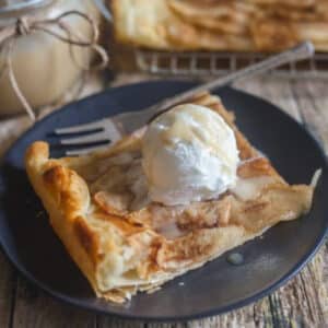 A slice of tart on a scoop of ice cream.