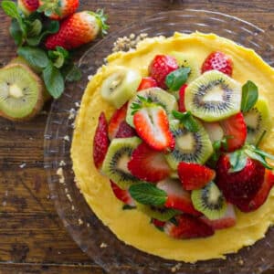 Fruit tart on a glass dish.