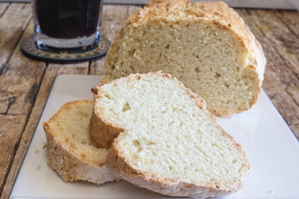 Irish soda bread and 2 slices on a white board