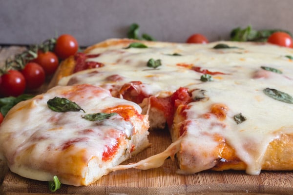 a slice cut of no knead pizza dough Pizza Margherita