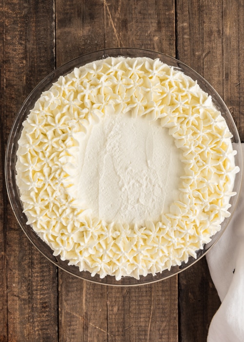 Decorating the pie with whipped cream.