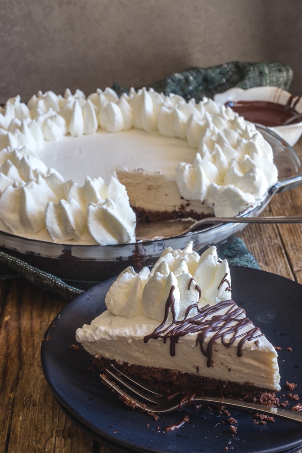 mousse pie with a slice on a black plate