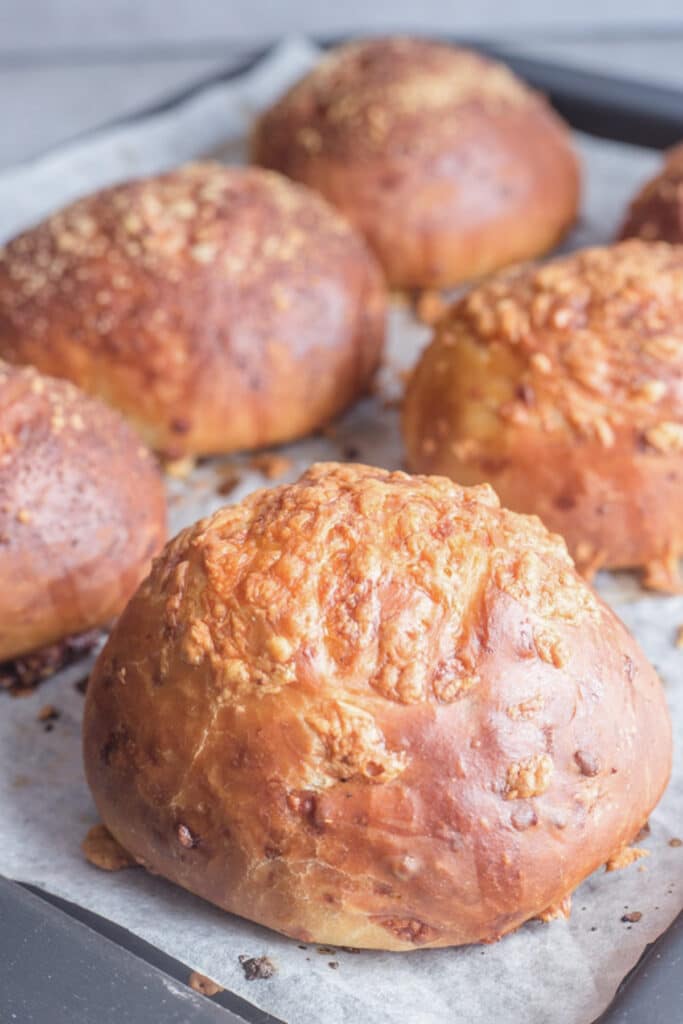 Baked bread buns on a baking sheet.