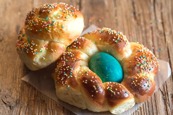 2 easter breads on a wooden board