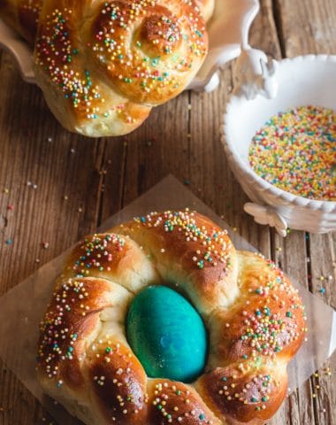 2 individual easter bread on a wooden board