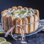 Lemon charlotte on a glass cake stand.