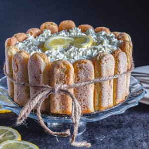 Lemon charlotte on a glass cake stand.