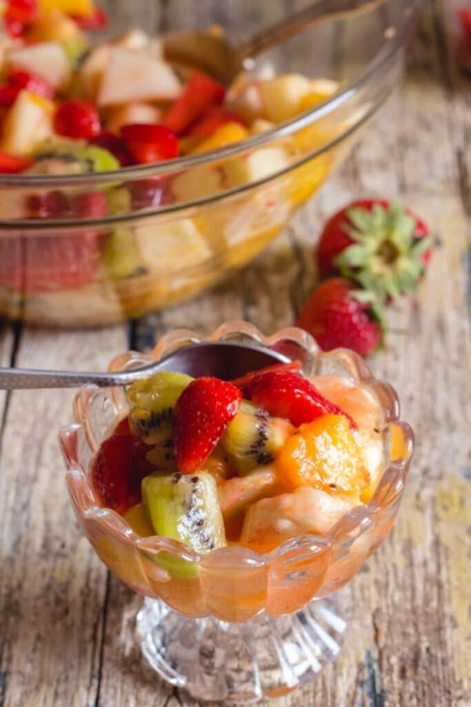 Fruit salad in a bowl and in a cup.