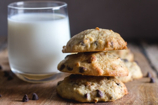 banana chocolate chip cookies 3 stacked with a glass of milk
