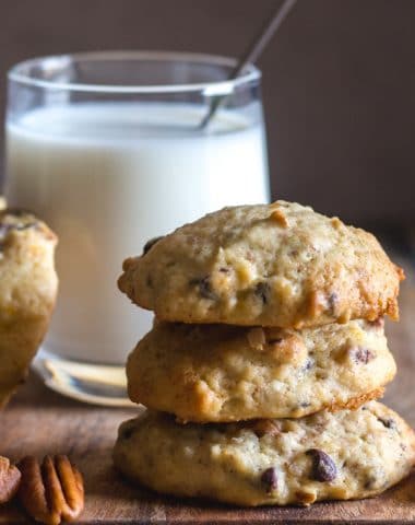 banana chocolate chip cookies 3 stacked with a glass of milk