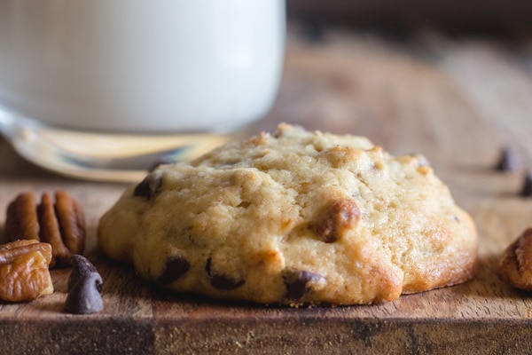 one banana chocolate chip cookie on a wooden board