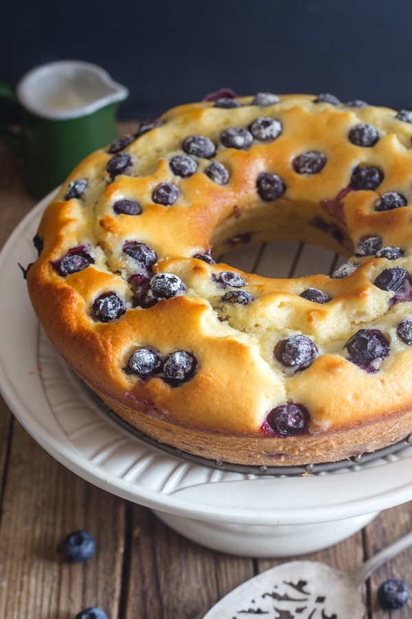 blueberry cake on a white stand