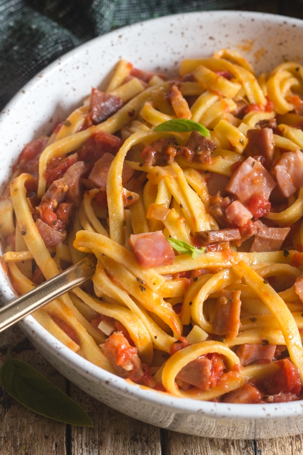 double pancetta pasta in a white bowl