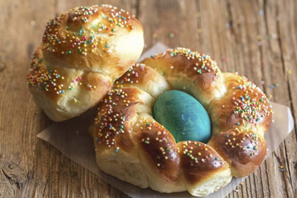 Two Easter breads on a wooden board