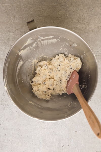 adding the chocolate chips to the creamed flour, butter and sugar mixture