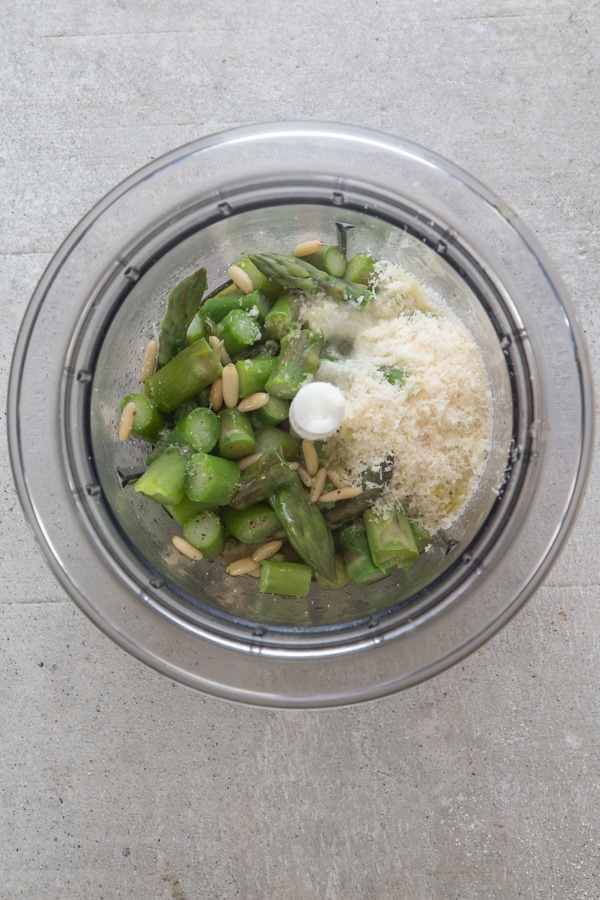 ingredients for asparagus pesto in a blender