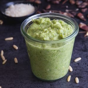 asparagus pesto in a glass jar on a black board