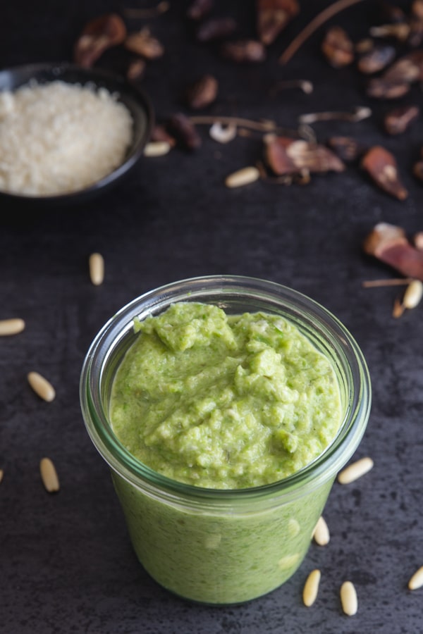 asparagus pesto in a glass jar on a black board