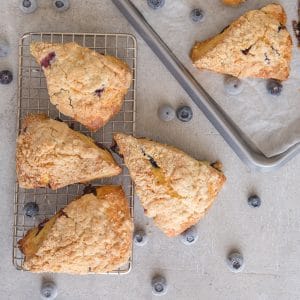 blueberry scones on a pan and a grey board