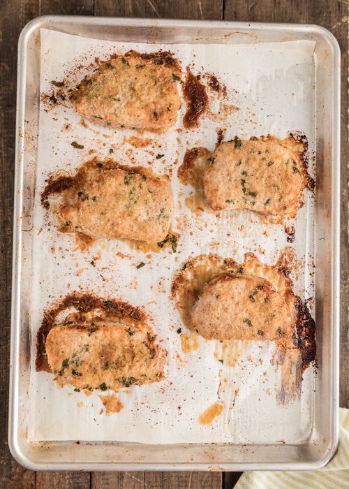 The pork chops on a baking sheet after baking.