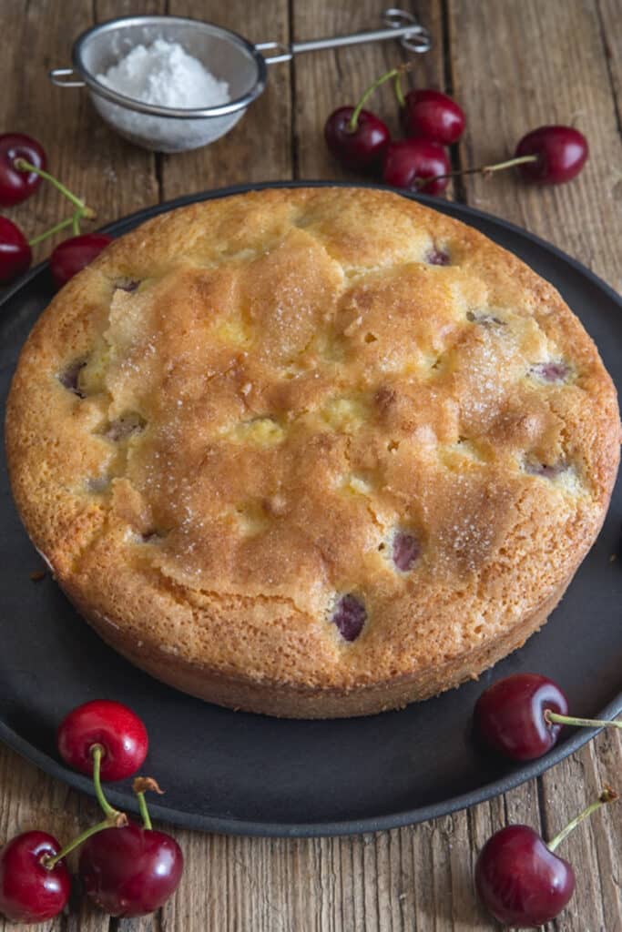 Cherry cake on a black plate.