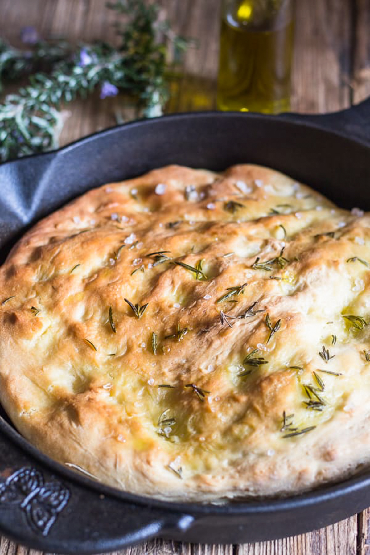 Baked focaccia in a black pan.