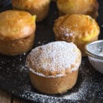 Pastry on a black pan with powdered sugar