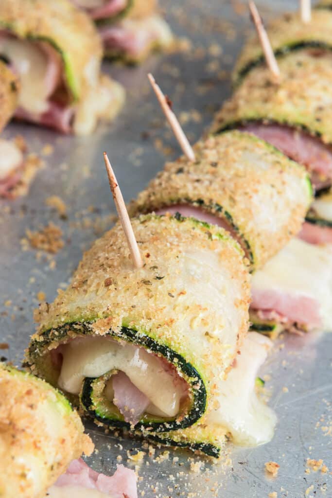 The baked zucchini rollups on a baking sheet.