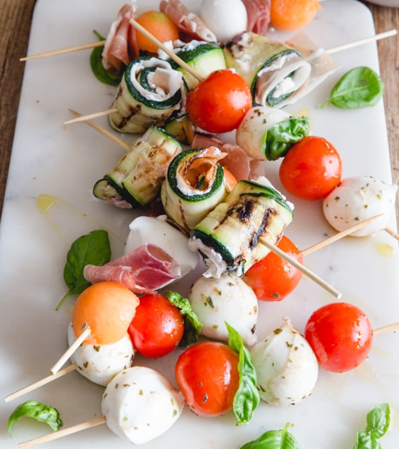 antipasto skewers on a white board