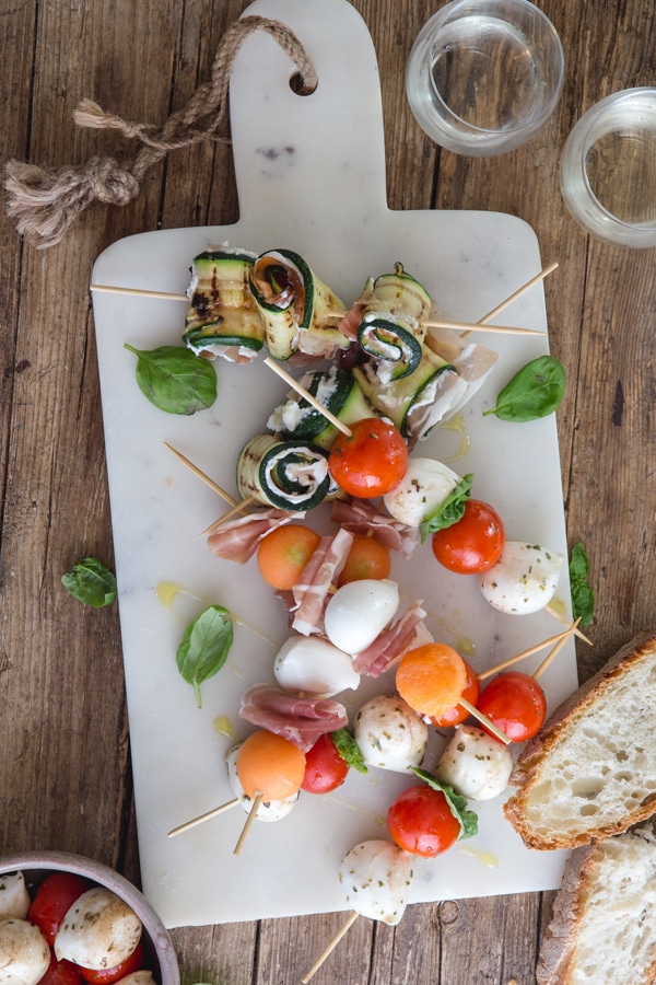 antipasto skewers on a white board